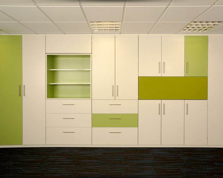 Fitted storage wall with multi-coloured doors.
